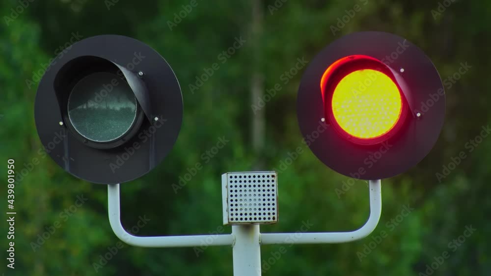 Railway traffic light flashes blinks red. Closed crossing. Forbidding stop signal at railroad