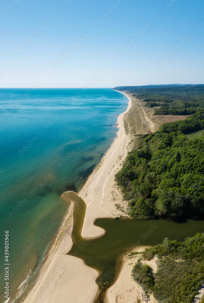Beautiful aerial view of a sandy beach and a river that flows into the sea, the mouth of Kamchia River at the Black sea coast, Bulgaria