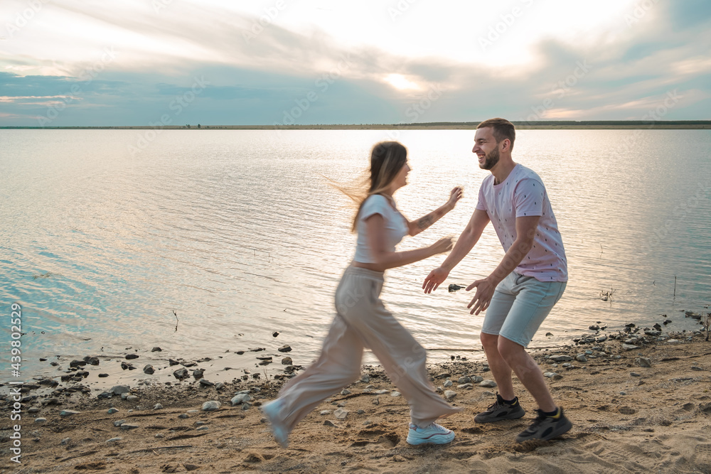 beautiful young girl runs at her boyfriend to jump into his arms