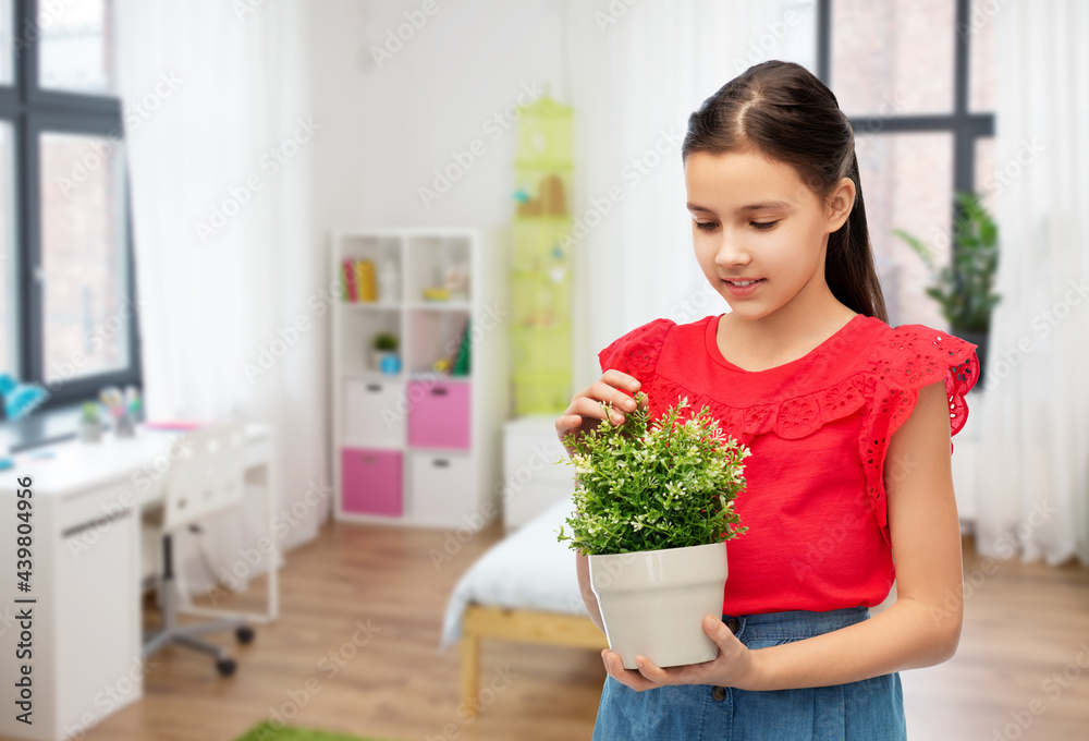 environment, nature and people concept - happy smiling girl holding flower in pot over kids room background environment, nature and people concept - happy smiling girl holding flower in pot over kids room background