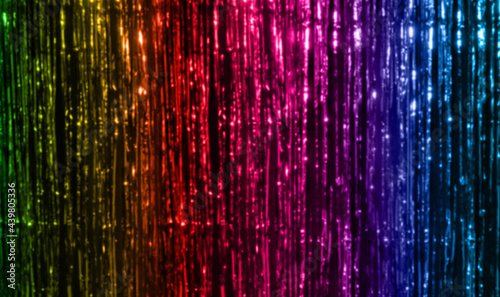 lgbt, decoration and gay symbolic concept - background of foil fringe curtain in rainbow colors photo