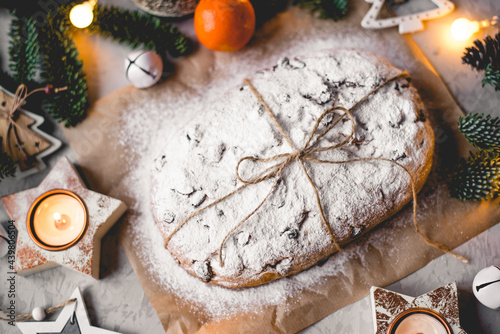 Traditional german stollen cake with Christmas decorations on the table.