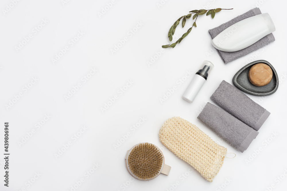 Bath accessories from natural material, zero waste set for bathroom, bottle with gel or shampoo, soap, wooden hairbrush, washcloth on white table with copy space. Bath accessories from natural material, zero waste set for bathroom, bottle with gel or shampoo, soap, wooden hairbrush, washcloth on white table with copy space.