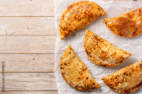 Traditional Chilean empanadas on rustic wooden table . Top view. Copy space