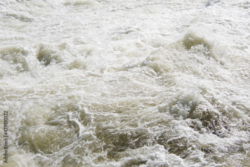 High water current with foam and splashes.