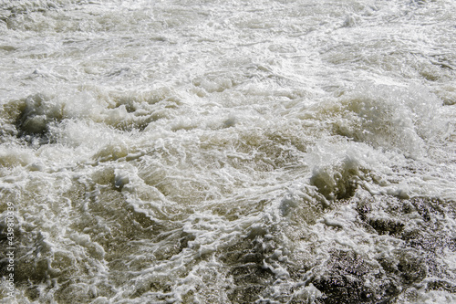 High water current with foam and splashes.