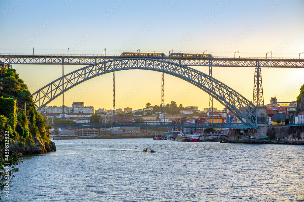 Cityscape of Porto with Douro river and famous bridge by sunset, Portugal