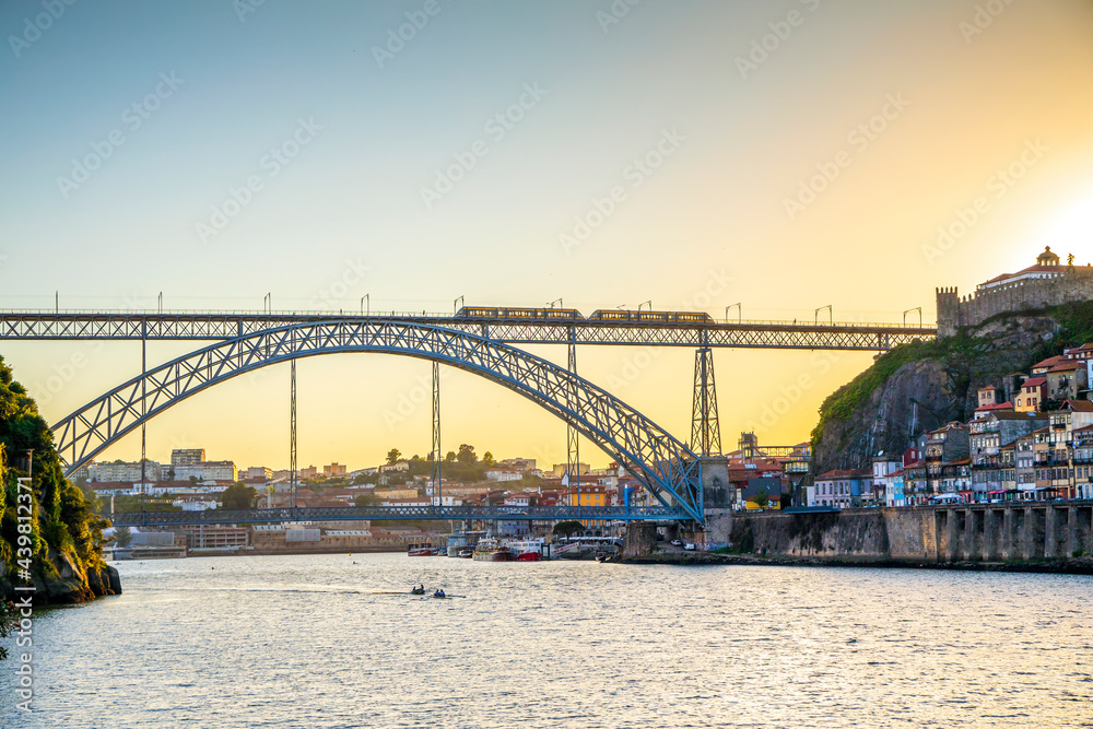 Naklejka premium Cityscape of Porto with Douro river and famous bridge by sunset, Portugal