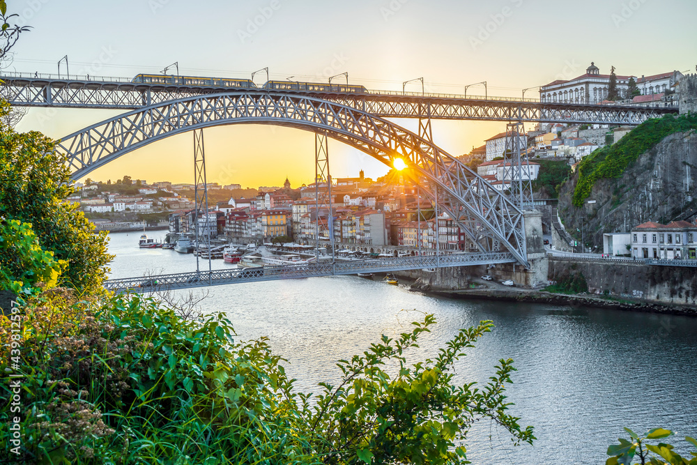 Cityscape of Porto with Douro river and famous bridge by sunset, Portugal