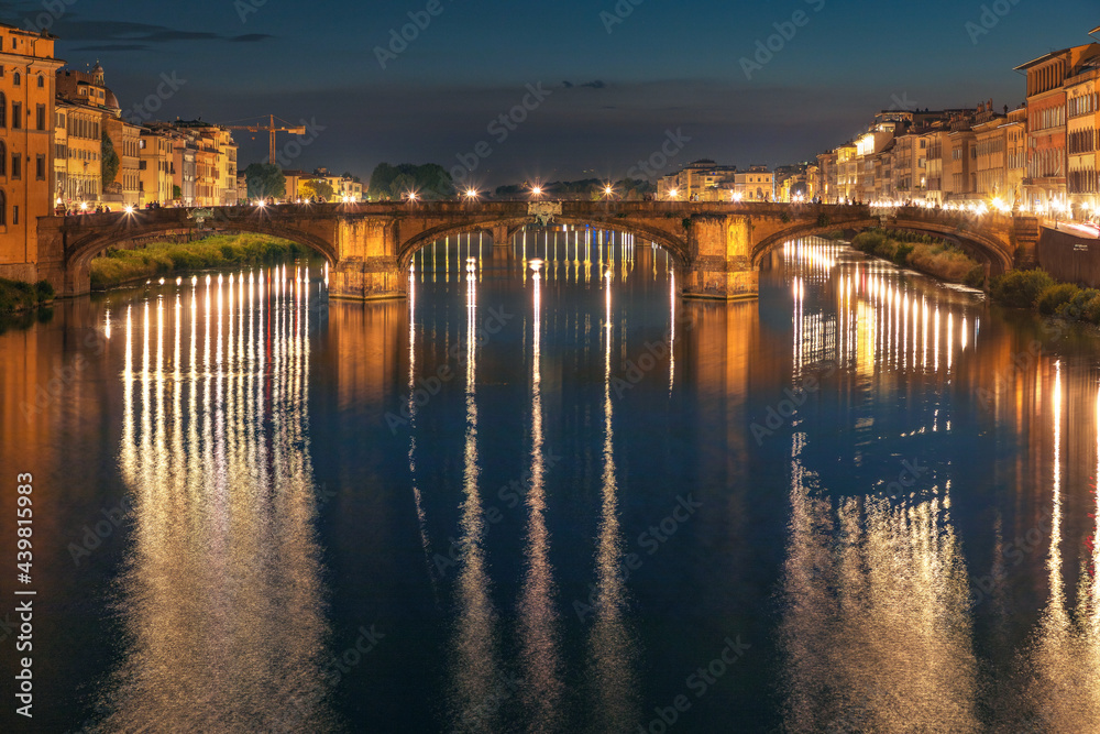 Florence, Italy -20 June, 2019 : view of St Trinity Bridge and river Arno at night.