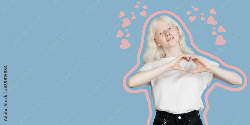 Smiling young girl showing heart with two hands, love sign. Isolated over blue background. Smiling young girl showing heart with two hands, love sign. Isolated over blue background.