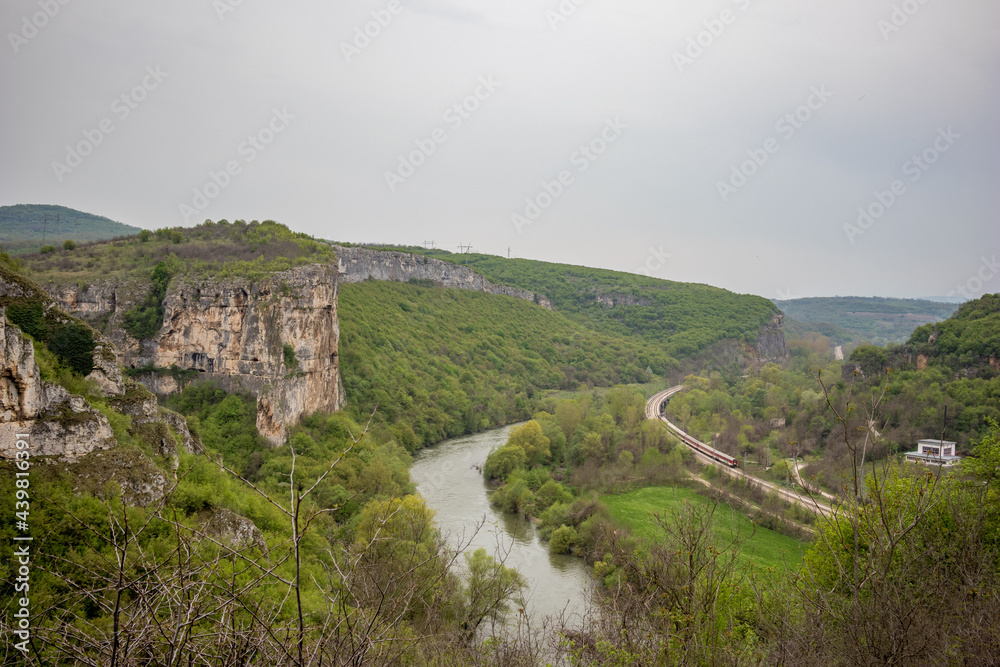 Iskar river gorge from above near Karlukovo, Bulgaria. Rail road, moody day panoramic high angle elevated view