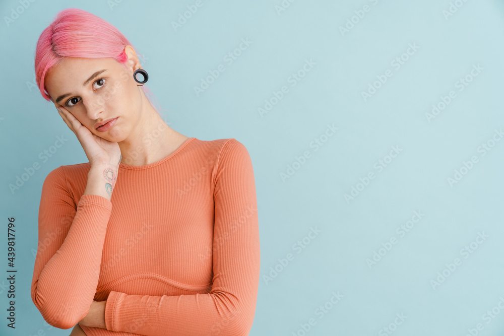 Young white woman looking at camera while propping up her head Young white woman looking at camera while propping up her head