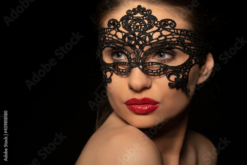 Beautiful woman with lace mask and make up