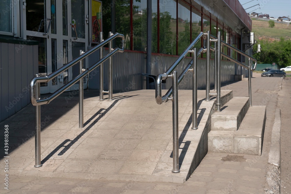 Shiny steel handrails at the entrance to the store. Shiny steel handrails at the entrance to the store.