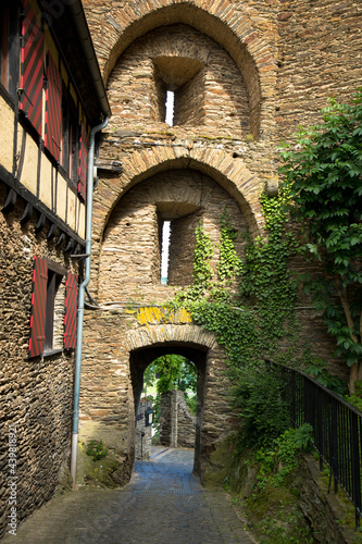 The courtyard of Schoenburg Castle. Sandstone arches overgrown with ivy. Oberwesel, Rhineland-Palatinate, Germany photo