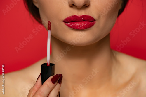Fotografie, Obraz a woman advertises a red lip gloss