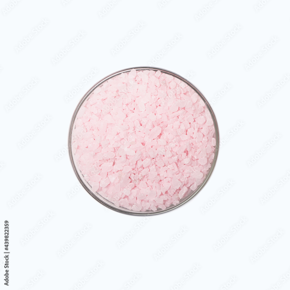 Himalayan pink salt in bowl on white background Himalayan pink salt in bowl on white background