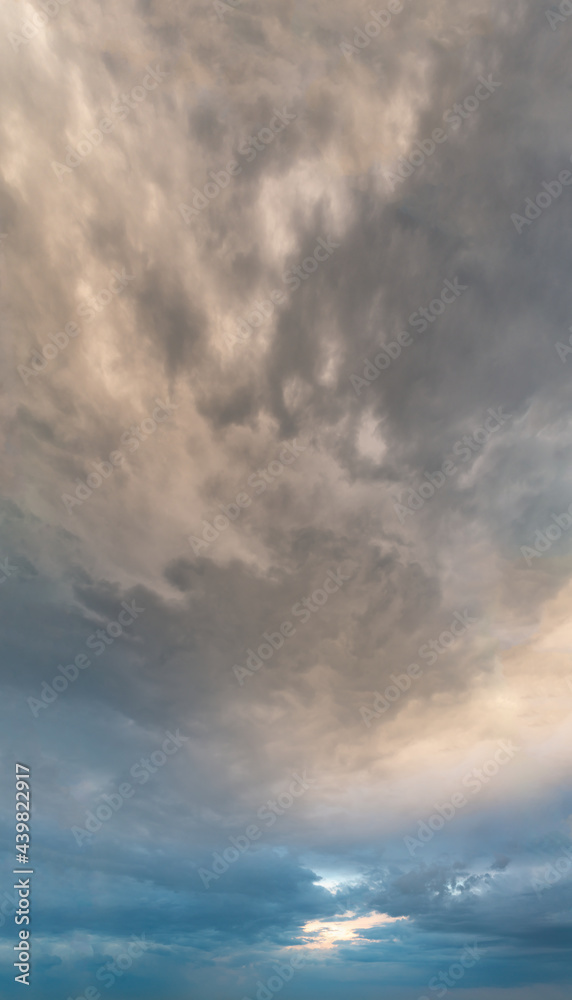 Fantastic clouds at sunrise, vertical panorama