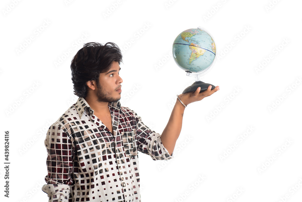 young man with a world globe on a white background. young man with a world globe on a white background.