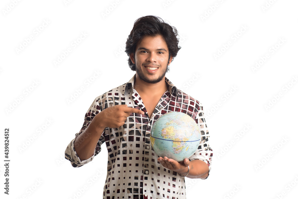 young man with a world globe on a white background. young man with a world globe on a white background.
