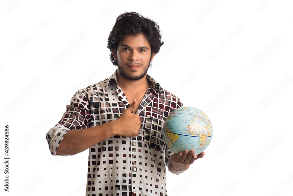 young man with a world globe on a white background. young man with a world globe on a white background.