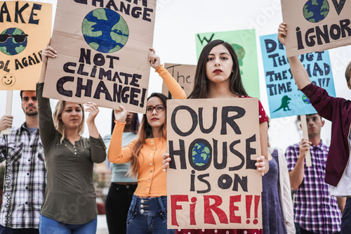 Group of demonstrators on road, young people from different culture and race fight for climate change - Focus on center girl face © DisobeyArt