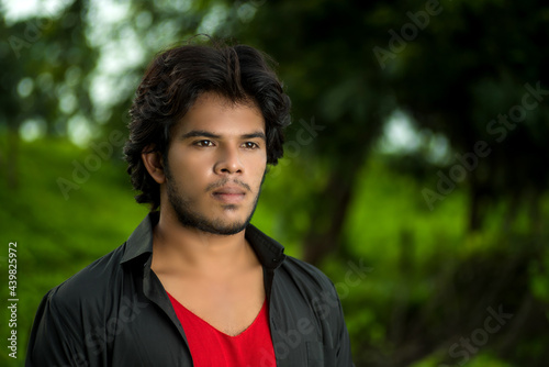 Handsome fashion young man posing outdoors