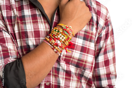 Young men showing rakhi on his hand on an occasion of Raksha Bandhan festival.