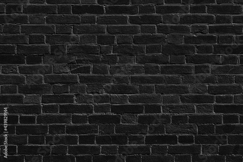 Black old rough brick wall texture. Shabby aged weathered dark gray brickwork. Abstract grunge background