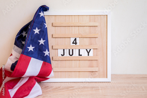 Fototapeta Naklejka Na Ścianę i Meble -  Light box with text HAPPY 4 JULY on a wooden background.  Independence Day USA concept. Greeting card.