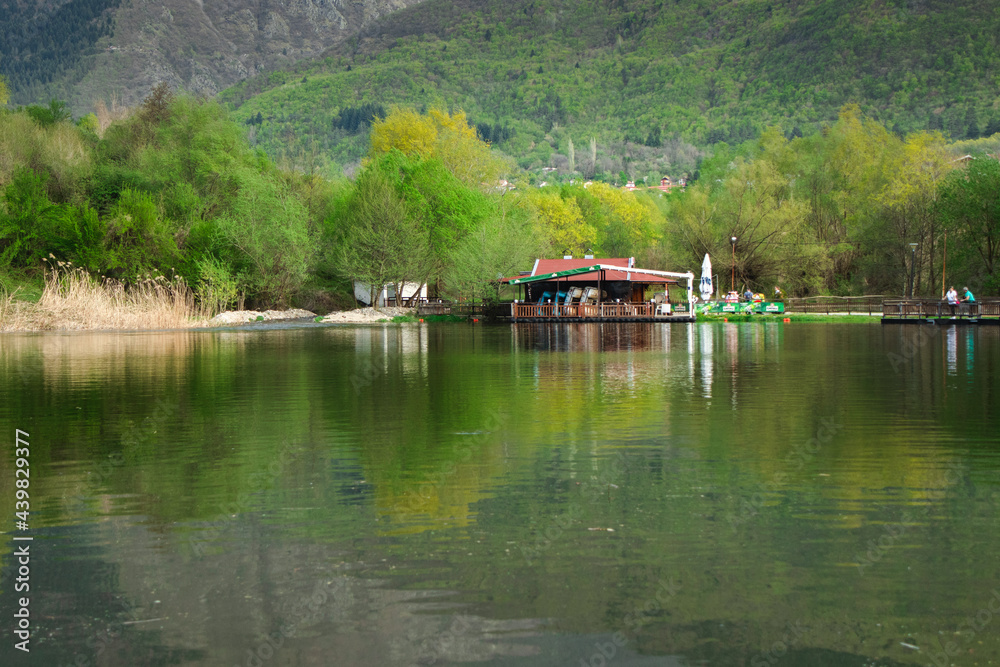 Fototapeta premium Lake by the mountain with reflection in the water of nature
