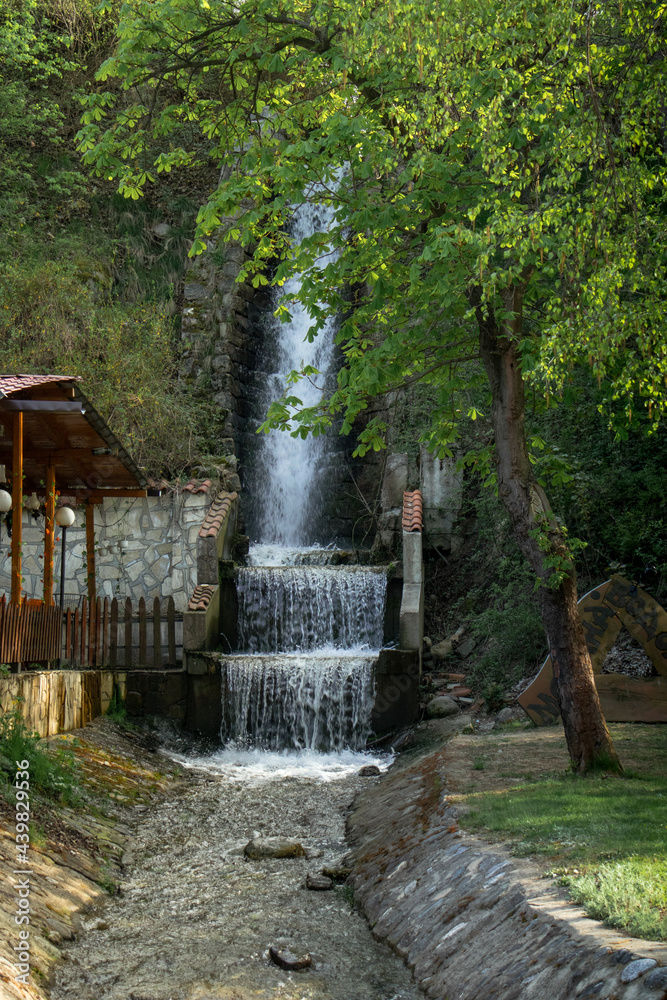A small waterfall, running water in nature, in a park