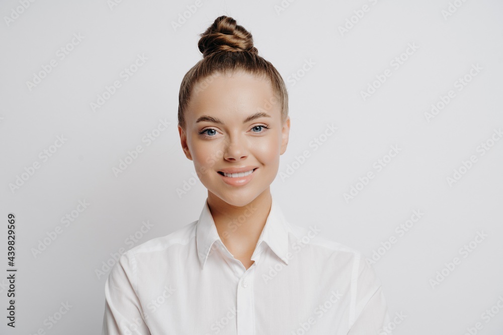 Happy successful business woman in white shirt posing in studio Happy successful business woman in white shirt posing in studio