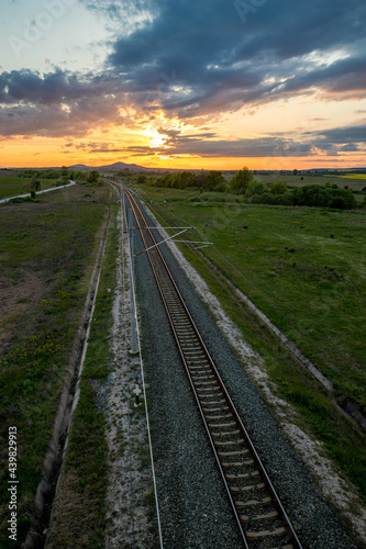 Railway as seen from above, shortly before sunset, cloudy dramatic sky.