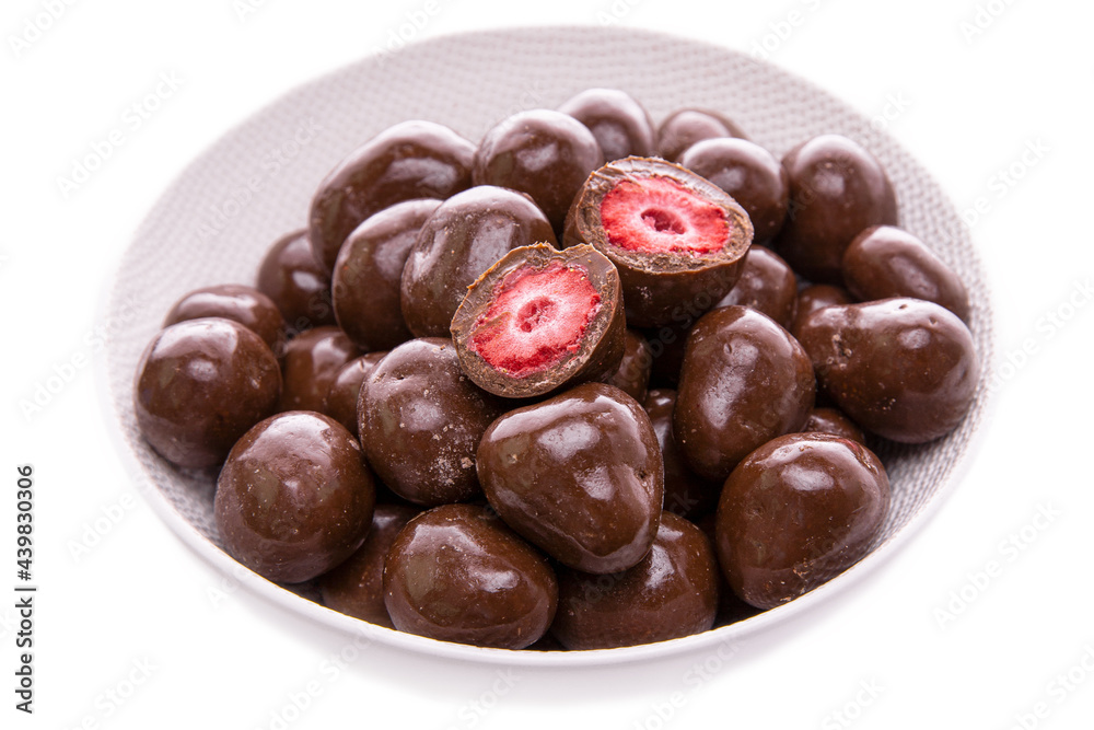 strawberries in dark chocolate.candies. in a white dish close-up.isolated food products strawberries in dark chocolate.candies. in a white dish close-up.isolated food products