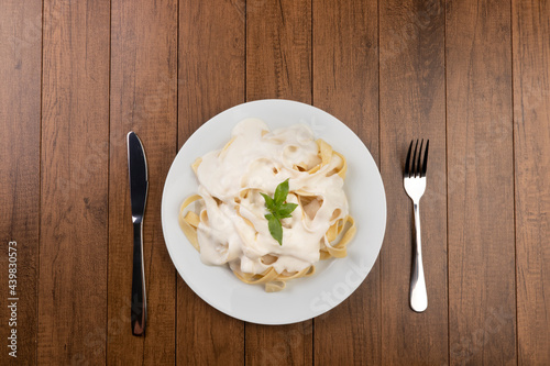 Принти на полотні Tagliatelle pasta served with bechamel sauce and basil leaves