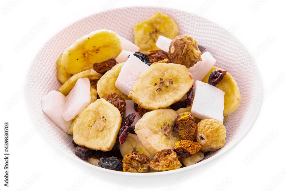 a mixture of chopped dried fruits and berries, nuts in a white plate on a white background. Isolated items and products