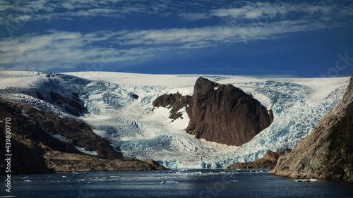 glacier in the mountains. Magnificent landscape with glasier, iceberg, mountains, sky and sea, Christiansud, Greenland