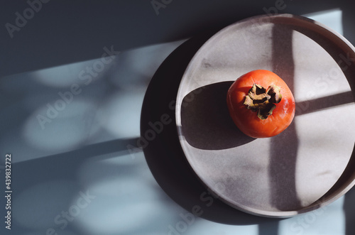 Persimmon on a blue background.