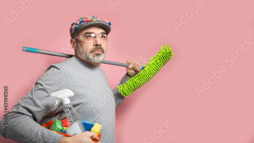 Spring cleaning funny middle aged man with a mop and wearing protective glasses