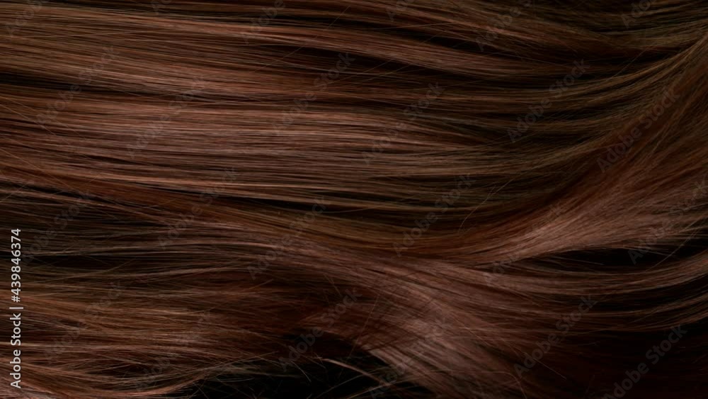 Super slow motion of beautiful healthy long smooth flowing brown hair. Filmed on high speed cinematic camera at 1000 fps.
