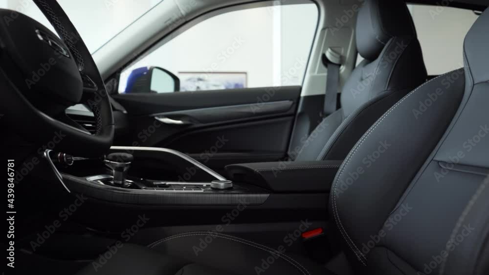 Close-up of the front car seats made of gray leather with white stitching. Close-up of the front car seats made of gray leather with white stitching.