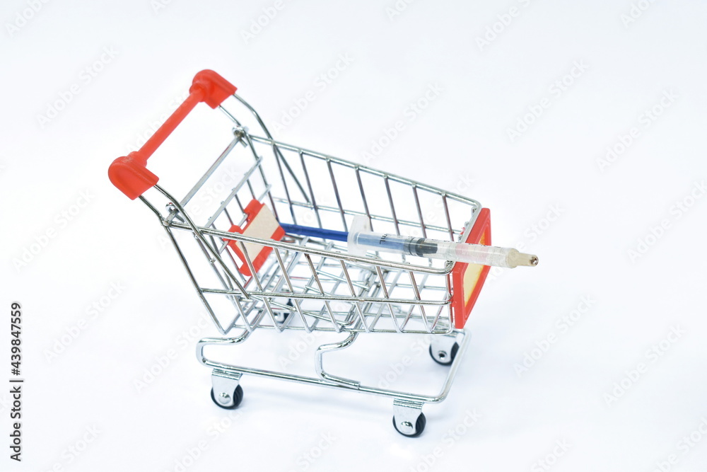 syringe medical equipment with yellow liquid vaccine on cart in white background