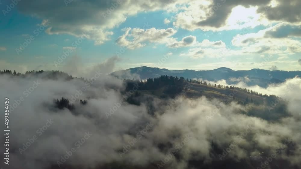 Flying over a mountain landscape in the clouds Flying over a mountain landscape in the clouds