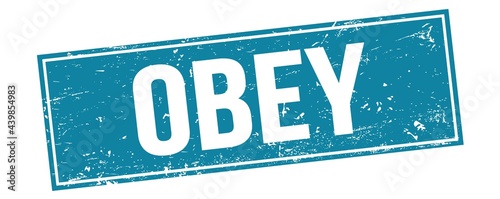 Fényképezés OBEY text on blue grungy rectangle stamp.