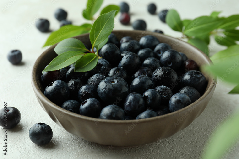 Fresh berry concept with blueberry on white textured table Fresh berry concept with blueberry on white textured table
