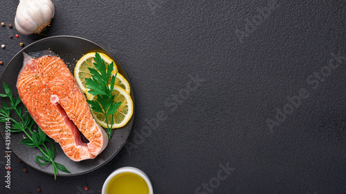 Raw salmon steak in ingredients for cooking with copy space