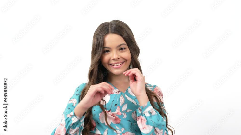 smiling kid turning with long curly elastic hair demonstrating hair care and health, hairdresser smiling kid turning with long curly elastic hair demonstrating hair care and health, hairdresser