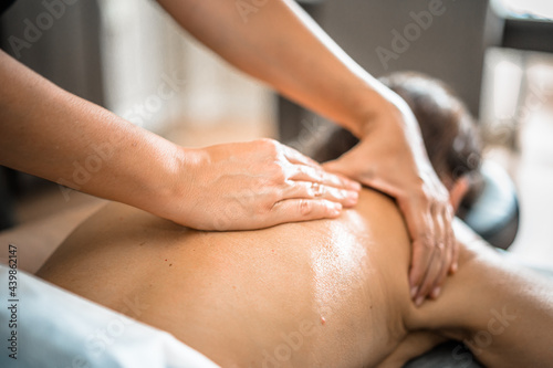 Deep tissue massage closeup view. Massage closeup with hands of professional masseur. Spa and job concept.